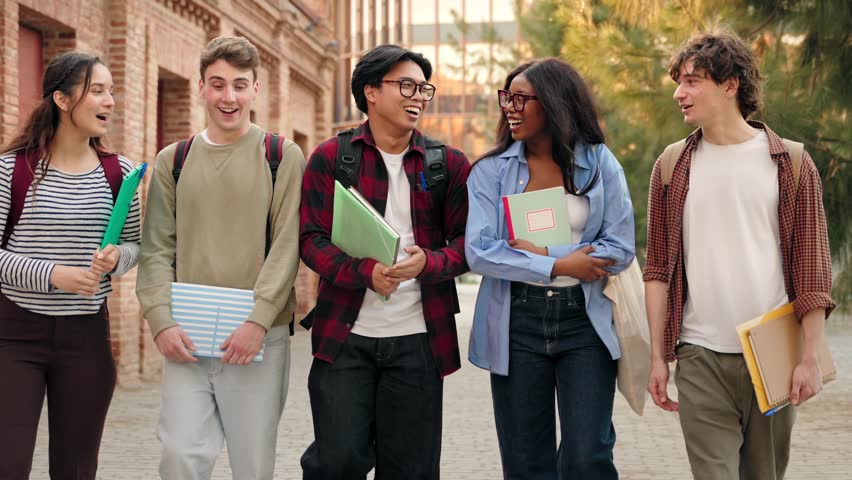 Group of University students talking and walking after classes on college campus 