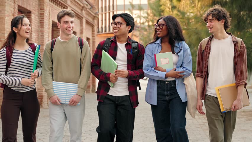 Group of University students talking and walking after classes on college campus 