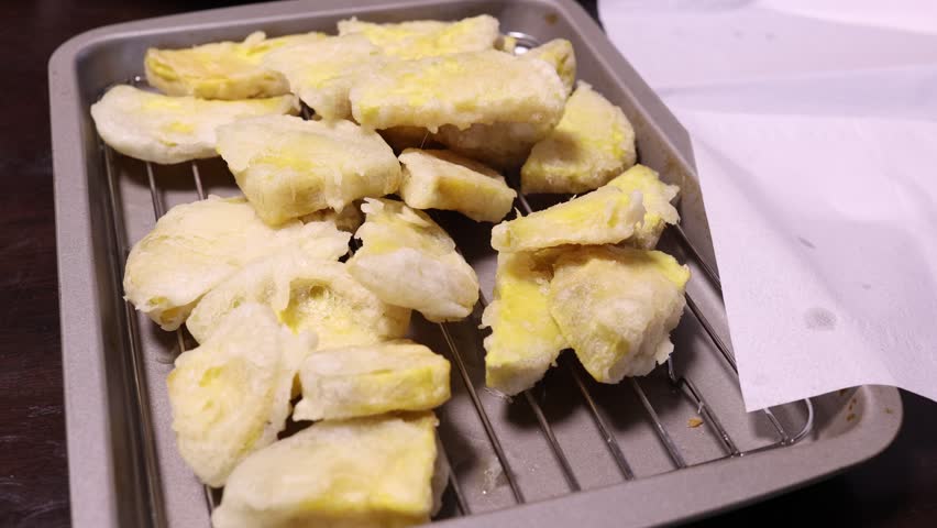 A mountain of freshly fried sweet potato tempura. Home-cooked food.