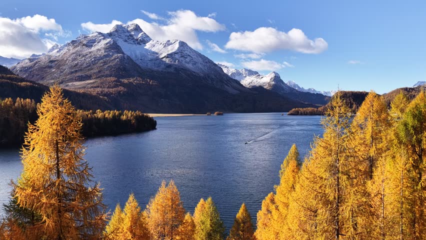 Autumn lake with snowy mountains in Engadin Switzerland