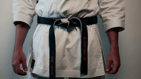 Martial arts expert tying a black belt  - Powered by Shutterstock - Get 15% off with code: PIKWIZARD15