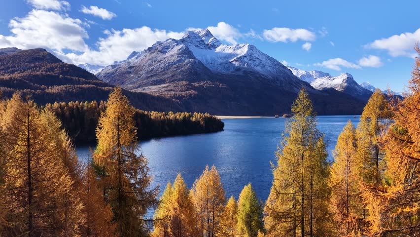 Autumn lake with snowy mountains in Engadin Switzerland
