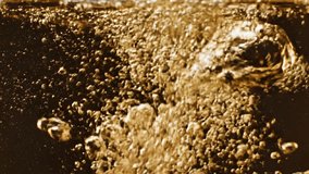 Golden Bubbles Rising in a Dark Liquid Close-Up Abstract Background. - Powered by Shutterstock - Get 15% off with code: PIKWIZARD15
