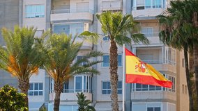 Spanish flag waving along the beachfront apartments in Benidorm, Alicante - Powered by Shutterstock - Get 15% off with code: PIKWIZARD15