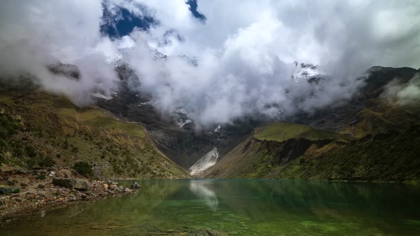 Lake Humantay glacier Laguna Humantay Peru Perú time lapse Peruvian Andes Mountain Range weather fog low cloud movement blue skies snow capped mountains high altitude elevation Salcantay trek static