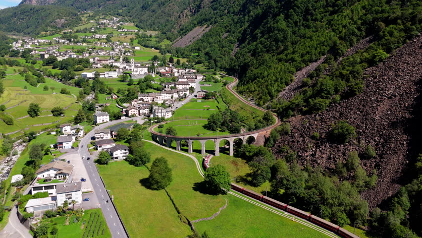 Bernina red train winds through lush Swiss mountains and quaint villages