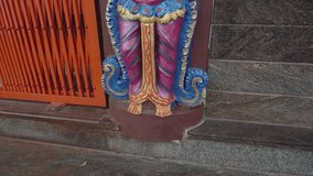 A vibrant statue of a Hindu guardian deity with folded hands stands at a temple entrance. The colorful sculpture features gold and red details, symbolizing protection and respect in Hindu culture. - Powered by Shutterstock - Get 15% off with code: PIKWIZARD15