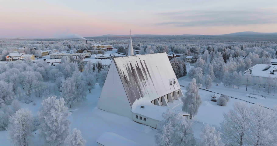 Aerial view orbiting the frosty church of Salla, polar night n Lapland, Finland