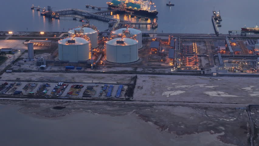 LNG (Liquified Natural Gas) tanker anchored in Gas terminal gas tanks for storage. Oil Crude Gas Tanker Ship. LPG at Tanker Bay Petroleum Chemical or Methane freighter export import transportation