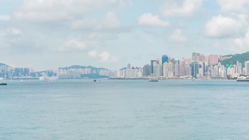 Distant cityscape view of Hong Kong across the water on a cloudy day in China