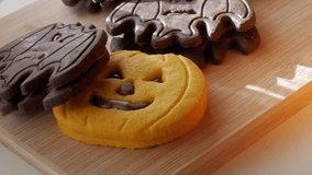 Pumpkin and bat-shaped Halloween cookies on wooden board - Powered by Shutterstock - Get 15% off with code: PIKWIZARD15