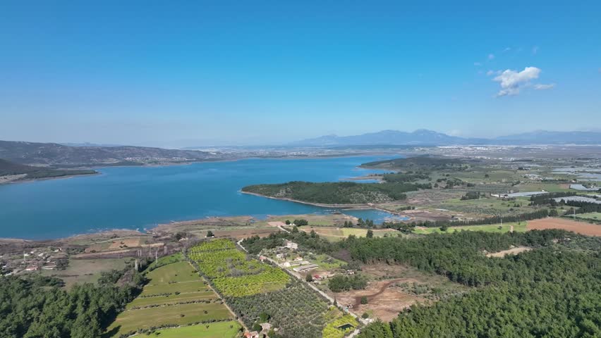 Panoramic Aerial View of Reservoir, Farmland, and Distant City Horizon