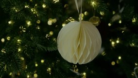 Paper Christmas tree ornament hanging on a branch. Holiday concept. New Year, Christmas. 4K slow motion video - Powered by Shutterstock - Get 15% off with code: PIKWIZARD15