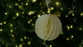 Paper Christmas tree ornament hanging on a branch. Holiday concept. New Year, Christmas. 4K slow motion video - Powered by Shutterstock - Get 15% off with code: PIKWIZARD15