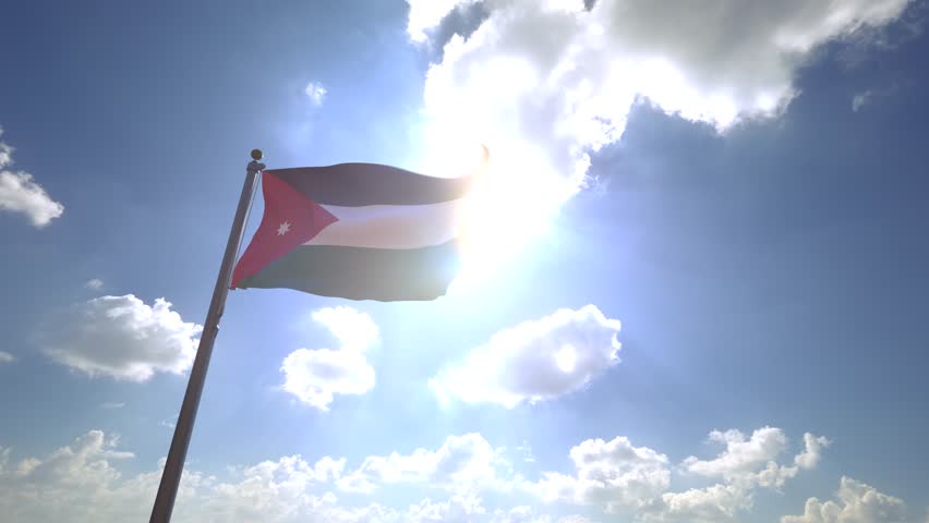 Jordan Flag on a Flagpole with a cloudy blue sky background