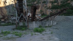 Capturing an abandoned quarry, this image showcases heavily rusted conveyor belts and industrial machinery against a rugged rock face, symbolizing industrial decay and environmental impact. - Powered by Shutterstock - Get 15% off with code: PIKWIZARD15