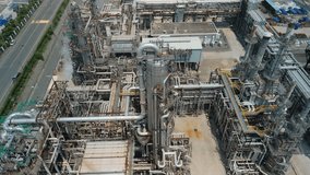 Aerial view of a vast industrial oil refinery or chemical plant, featuring complex pipelines, towers, and tanks. Ideal for illustrating energy production, manufacturing, and industrial infrastructure. - Powered by Shutterstock - Get 15% off with code: PIKWIZARD15