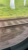 High-Speed Train View: Blurred Motion of Railroad Tracks and Green Landscape from Passenger Window - Powered by Shutterstock - Get 15% off with code: PIKWIZARD15