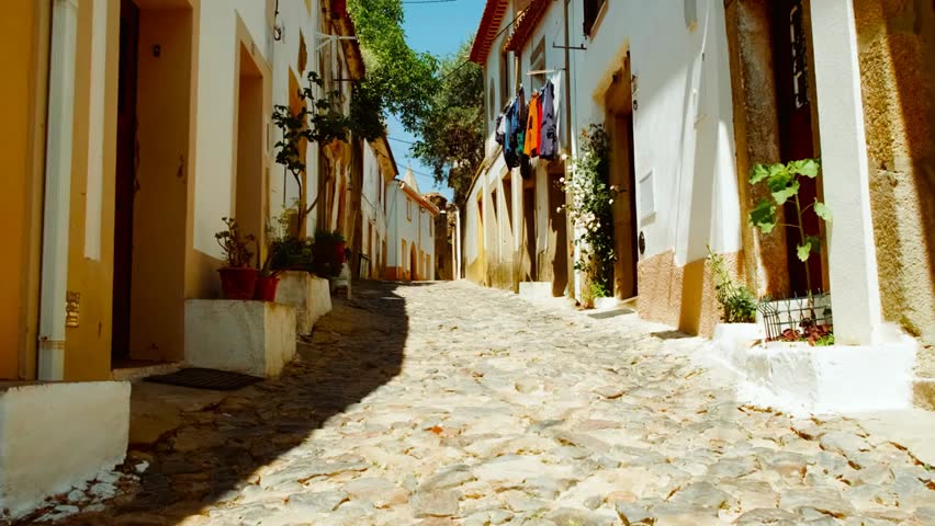 Quaint whitewashed streets wind through a charming historic town, highlighting serene alleys, traditional architecture, and a timeless atmosphere filled with cultural heritage.
