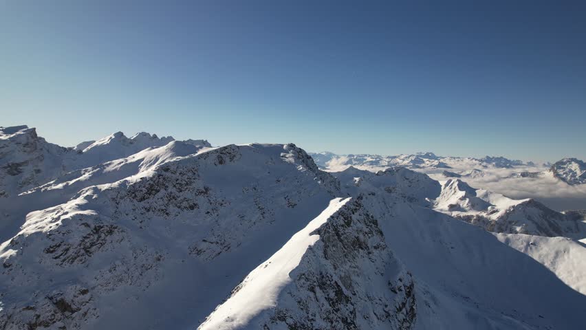 Winter wonderland in the mountains. Flying backwards with the view on the beatiful mountain Augstenberg.