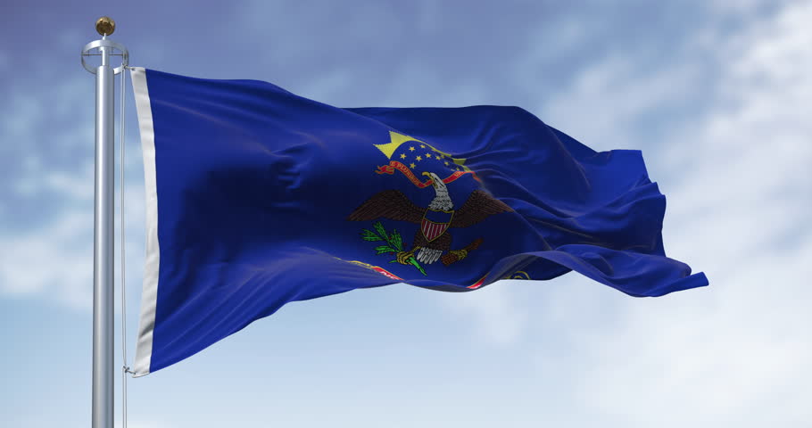 North Dakota state flag waving in the wind on a clear day. Blue with coat of arms. Eagle above North Dakota scroll. Seamless 3d render animation. Slow motion loop. Selective focus