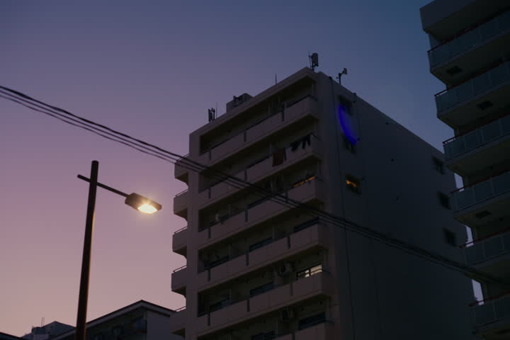 Evening view of Yokohama streets lit by neon lights and calm nighttime ambience.