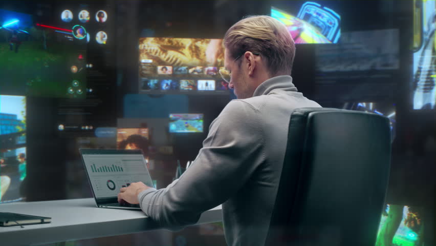 Male Professional Works on Laptop in a Office, Surrounded by Social Media Feeds, Video Calls, Analytics Dashboards, Gaming Streams, Online Data Video Content. 360 Degree Tracking Arc Shot