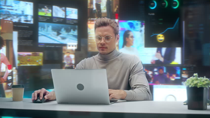 Male Professional Works on Laptop in a Office, Surrounded by Social Media Feeds, Video Calls, Analytics Dashboards, Gaming Streams, Online Data Video Content. 360 Degree Tracking Arc Shot