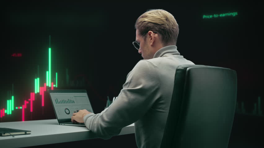 Financial Trader Analyzes Live Candlestick Charts on Multiple Screens, Executing Stock Market Strategies, Monitoring Volatility, and Managing Digital Investments. 360 Degree Tracking Arc Shot