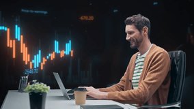 Smiling White Male Stock Trader Works on a Laptop. Monitoring Live Candlestick Charts, Analyzing Market Data, and Managing Investments While Sipping Coffee. 360 Degree Tracking Arc Shot - Powered by Shutterstock - Get 15% off with code: PIKWIZARD15