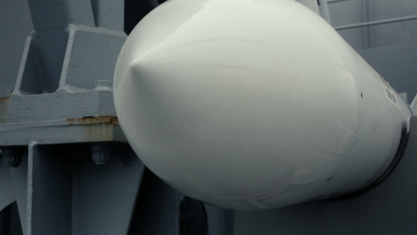 Close-up handheld dolly movement alongside a missile mounted on a U.S. Navy ship, showcasing modern naval weaponry and maritime military technology.