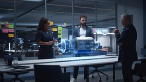 Diverse Team of Engineers, Collaborate in a Futuristic Office, Analyzing a Rotating Holographic Turbine Engine Model for Precision Engineering, Digital Twin Simulation, Advanced Product - Powered by Shutterstock - Get 15% off with code: PIKWIZARD15
