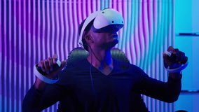 African American man working with VR technology future innovation in futuristic neon room cyberpunk gamer male guy in cyber futurism service using virtual reality metaverse with controllers developing - Powered by Shutterstock - Get 15% off with code: PIKWIZARD15