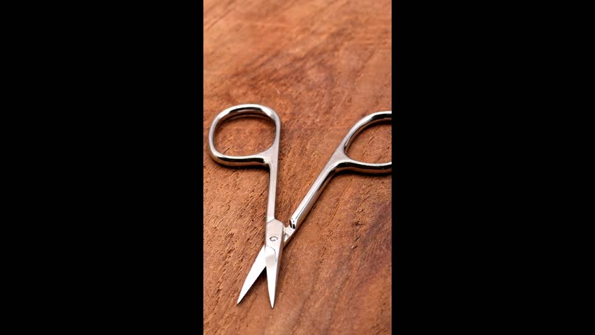 Scissors for cutting nails. Manicure, nail care, hygiene concept, vertical view
