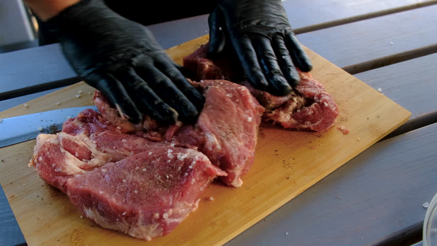 A man cutting meat. Selective focus.