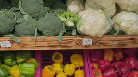 Broccoli, cauliflower and bell peppers on display at grocery store. Organic produce display at farmers market. Eco market stall with a variety of organic vegetables. Salad ingredients, vegan cuisine - Powered by Shutterstock - Get 15% off with code: PIKWIZARD15