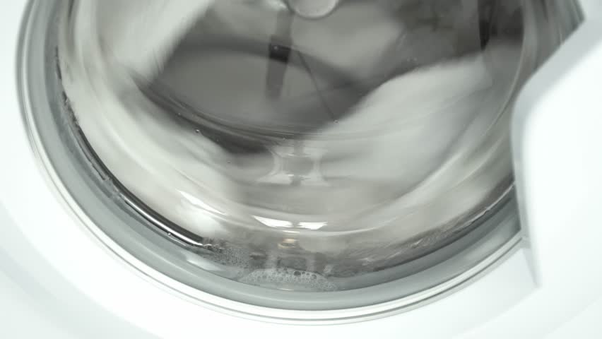 Washing machine washes white clothing. Cylinder spinning. Nobody