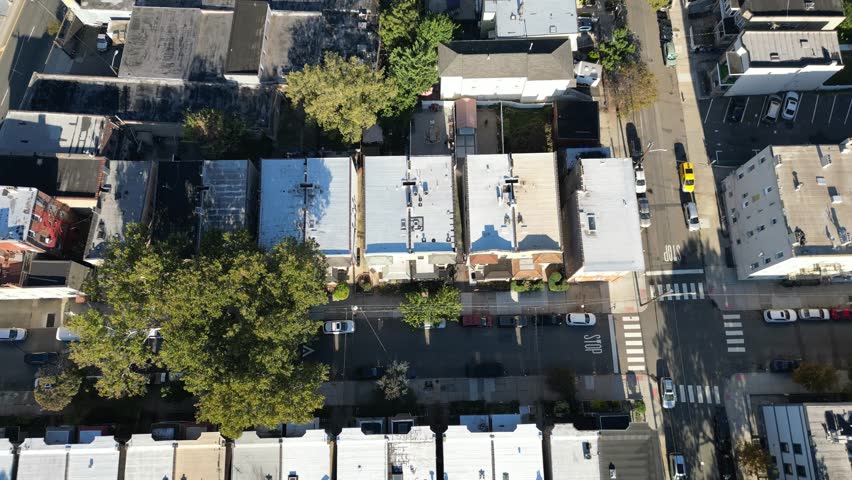 High vantage over Jersey City grid exposing housing clusters, tree-lined areas, and repeating architectural patterns.
