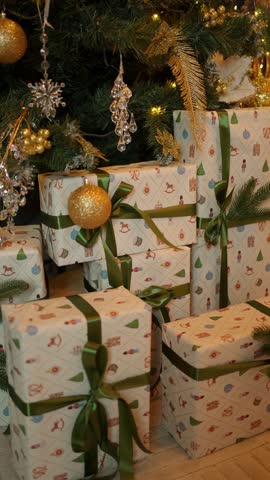 Luxurious Christmas gifts near a decorated fir tree. Concept of New Year's gifts.