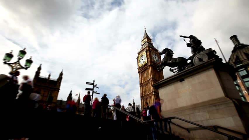 Crowds gather at Westminster, enjoying sights of Big Ben and surrounding historic buildings. Activity captures vibrant atmosphere of London during daytime, highlighting architectural beauty.