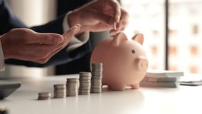 Businessman putting a coin into a piggy bank - Powered by Shutterstock - Get 15% off with code: PIKWIZARD15