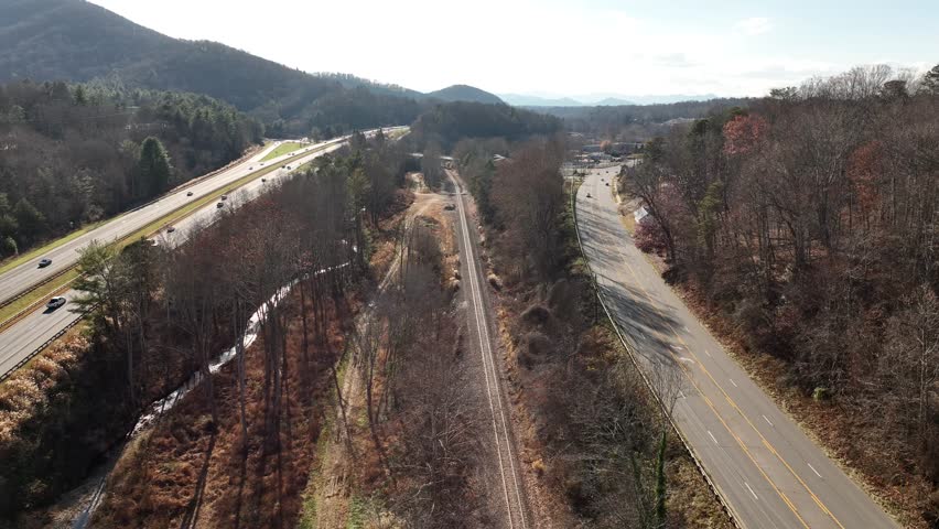 Autumn flight above railroad tracks.