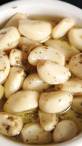 Garlic slices in flavored oil roasted garlic slice in oil fast food natural tasty appetizer fresh gourmet food background on the table rustic top view copy space vegetarian or vegan food