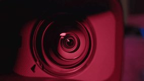 Camera lens Decorated with a colorful red and blue light background. Gradually zooming the camera lens, close-up. Detail of focus of the camera lens. - Powered by Shutterstock - Get 15% off with code: PIKWIZARD15
