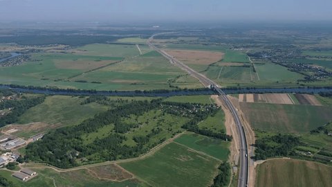 Highway Running along River through Open Fields