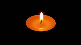 Time-lapse video of a tea candle burning on a dark background. The flame flickers, melts the wax, and gradually shortens as the light glows warmly against the darkness - Powered by Shutterstock - Get 15% off with code: PIKWIZARD15