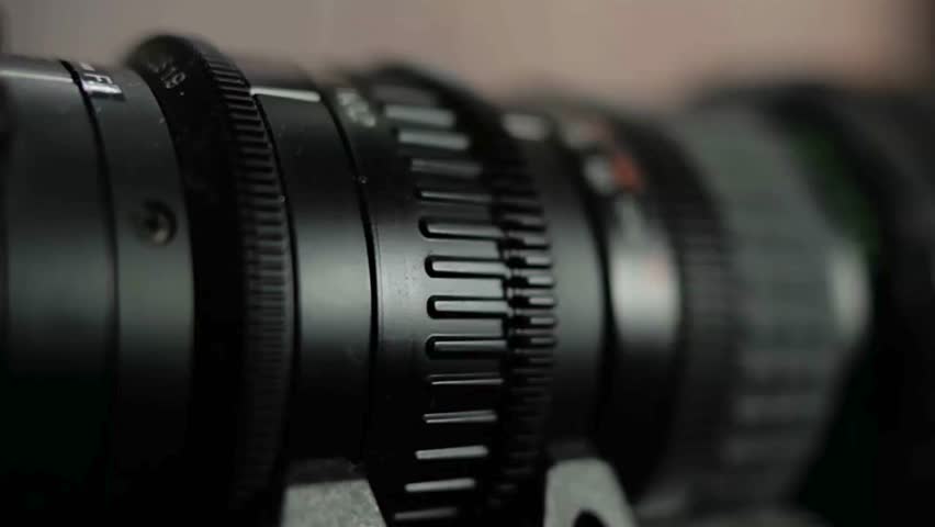 Photographer hand changing manual aperture ring on the camera lens. Lens camera manual focus. Changing exposure with aperture ring on manual lens.