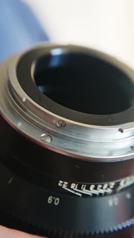 detailed camera mount features, close shot of textured lens mount with engraved numbers, closeup image capturing textured metal lens mount with engraved aperture markings and visible screws