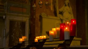 Flickering votive candles burning inside a church. Votive candles flickering on a metal stand inside a dimly lit church, creating a serene and spiritual atmosphere for prayer, worship, and remembrance - Powered by Shutterstock - Get 15% off with code: PIKWIZARD15