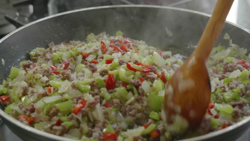 Sauteing Onions and Ground Meat in a Pan with Smoke Rising